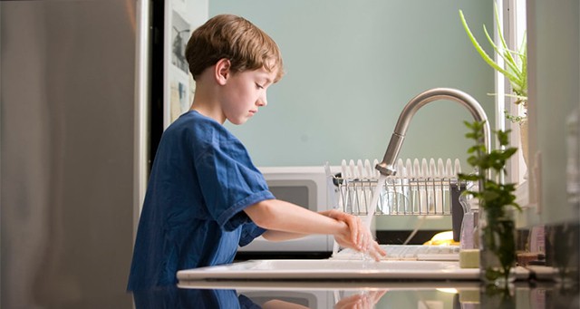 an image with kid washing his hands 