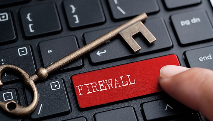an image with person pressing firewall button on keyboard with key over it