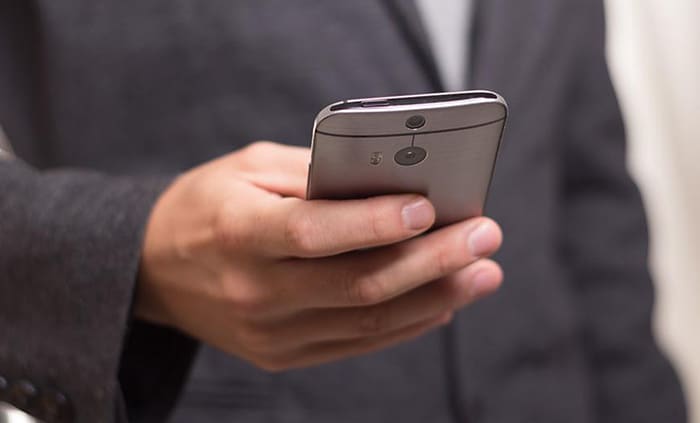 an image with person holding smartphone in his hand 