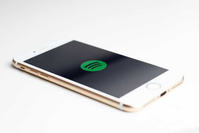 gold iPhone 7 displaying spotify logo