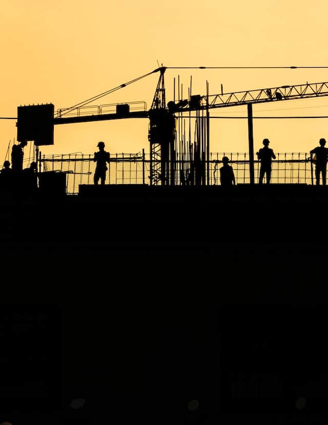silhouette of construction workers working