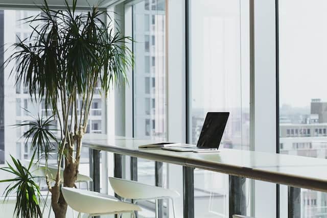 laptop computer on top of brown wooden table